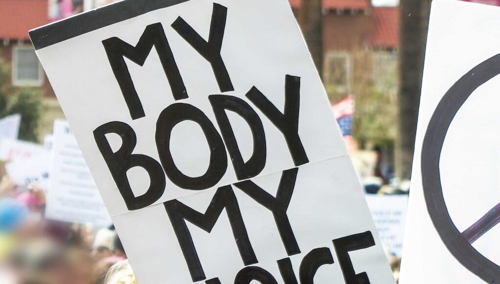 Women's rights and peace sign at political march. abortusz